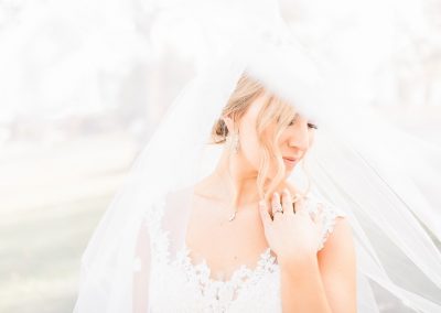 bride with beautiful veil poses at coopers ridge outdoor wedding venue