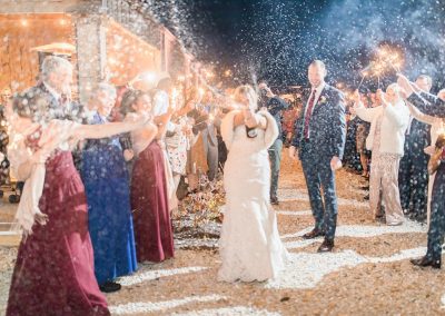 newlyweds pop a bottle at outdoor wedding reception
